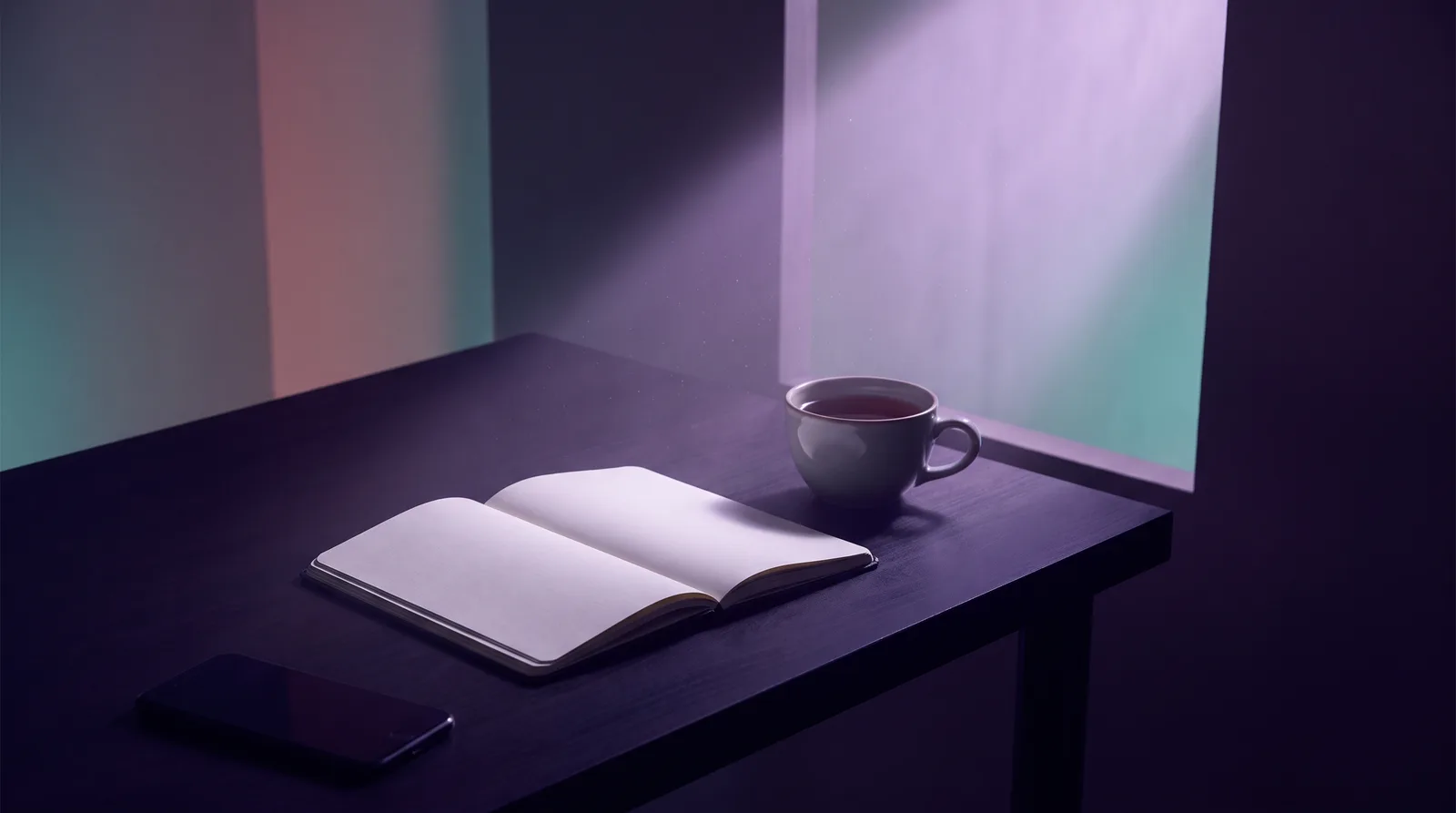 A single beam of lavender light on an open notebook and cup of tea in a dark aubergine room, a phone lying face-down in shadow.