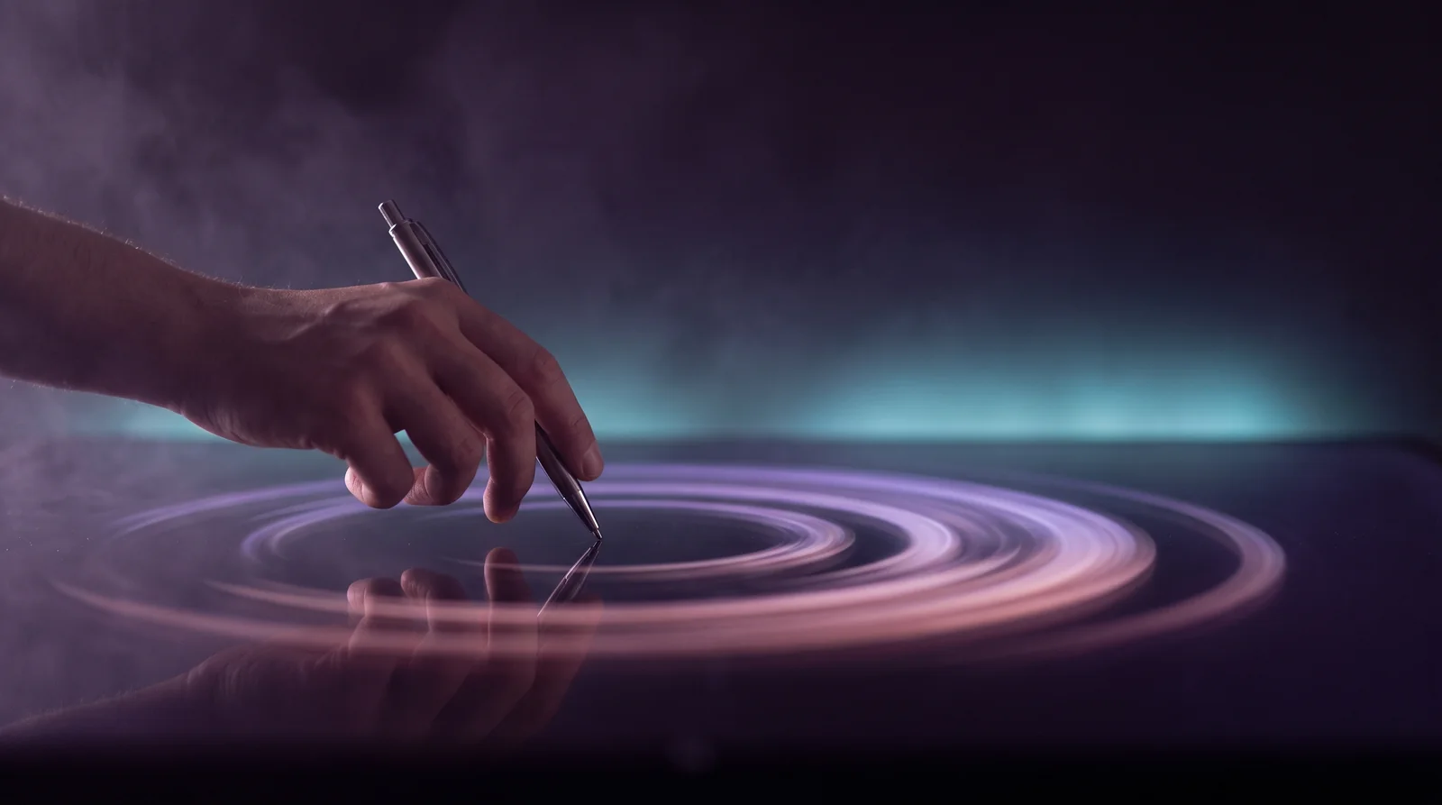 A hand tapping a pen with soft motion-blur trails of lavender and rose light rippling outward across a deep aubergine near-black surface.